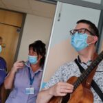Healthcare Musician Nick Cutts making music with patients and healthcare staff