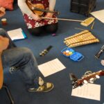 A picture of a music making session with guitars xylophones