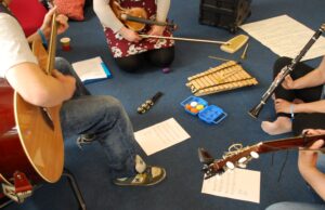 A picture of a music making session with guitars xylophones