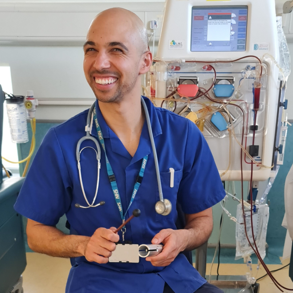 Image of a healthcare professional music making with a big grin on his face
