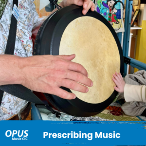 Prescribing music image of a bodhran and two hands playing in a hospital